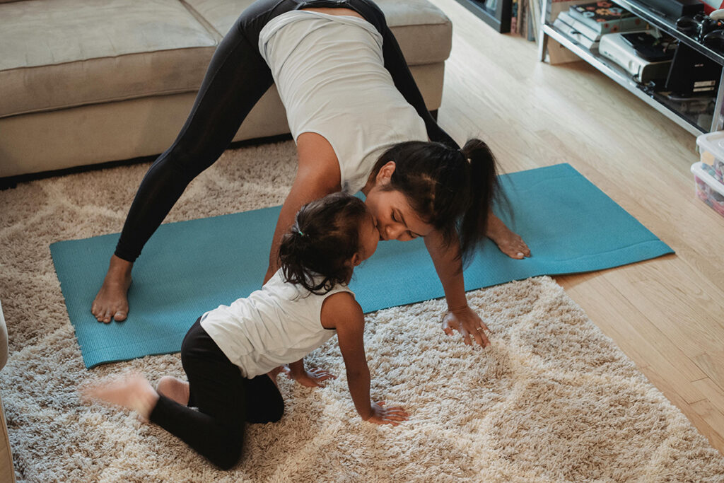 self-care isn't a spa day; mom doing exercise with toddler